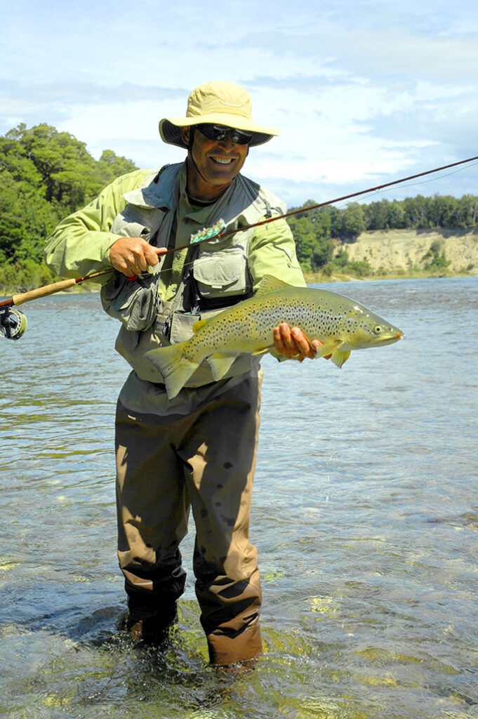 David Glasscock fly fishing guide holding a trout in an Idaho river.