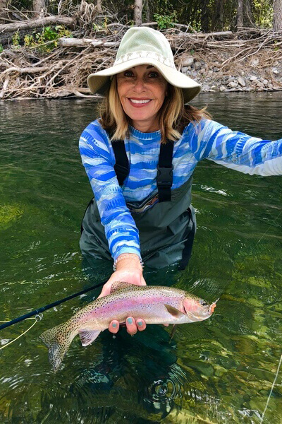 Woman holding trout in Big Wood River.
